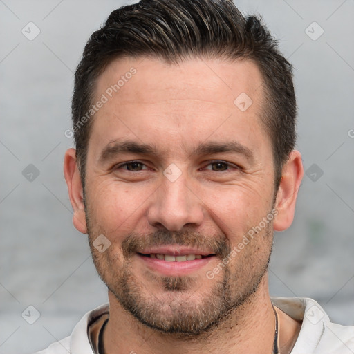 Joyful white adult male with short  brown hair and brown eyes