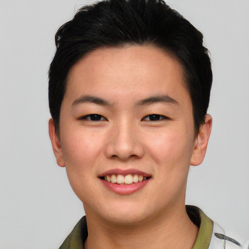 Joyful asian young-adult male with short  black hair and brown eyes