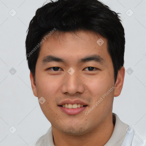 Joyful asian young-adult male with short  black hair and brown eyes