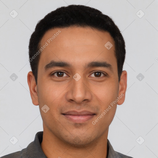 Joyful latino young-adult male with short  black hair and brown eyes