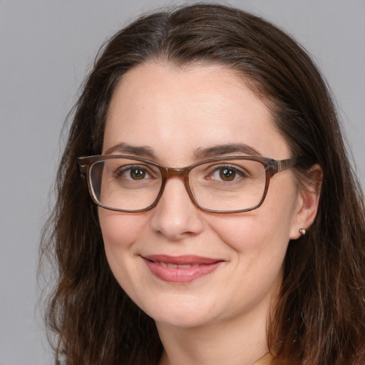 Joyful white adult female with medium  brown hair and brown eyes