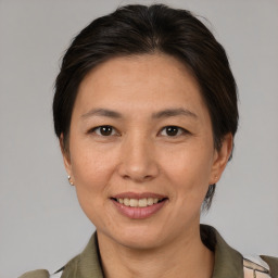 Joyful white adult female with medium  brown hair and brown eyes