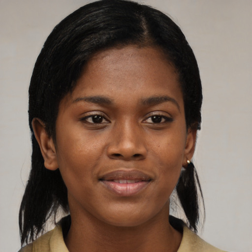 Joyful black young-adult female with medium  black hair and brown eyes