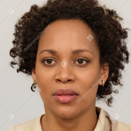 Joyful black adult female with short  brown hair and brown eyes