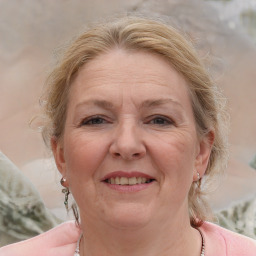 Joyful white adult female with medium  brown hair and blue eyes