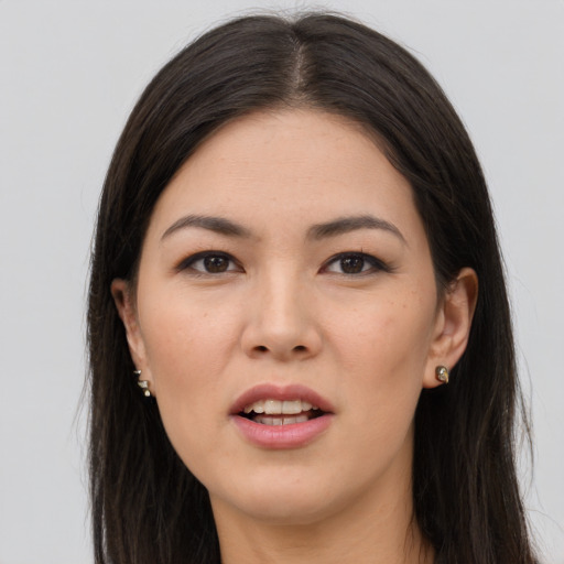 Joyful asian young-adult female with long  brown hair and brown eyes