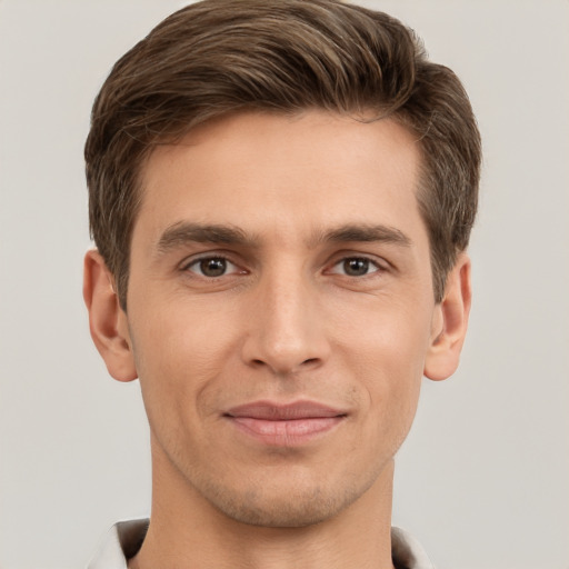 Joyful white young-adult male with short  brown hair and grey eyes