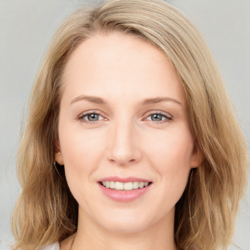 Joyful white young-adult female with long  brown hair and blue eyes