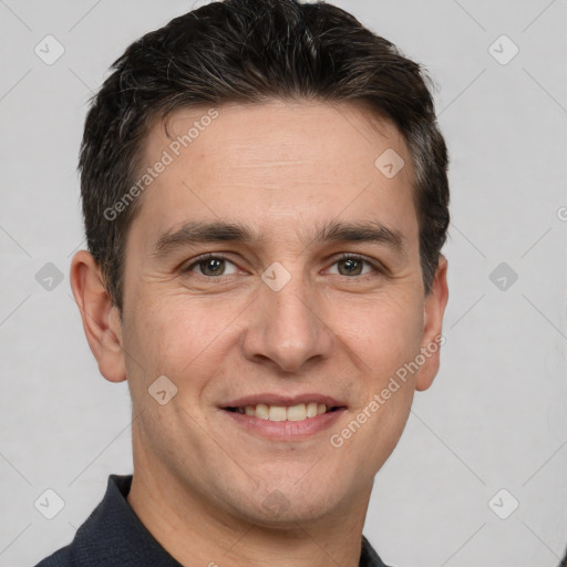 Joyful white adult male with short  brown hair and brown eyes