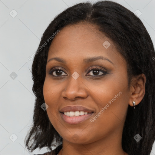 Joyful black young-adult female with long  brown hair and brown eyes