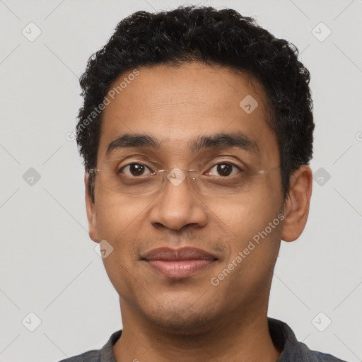 Joyful latino young-adult male with short  brown hair and brown eyes