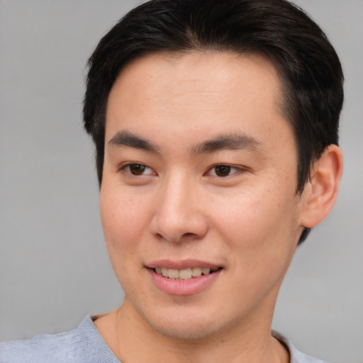 Joyful asian young-adult male with short  brown hair and brown eyes