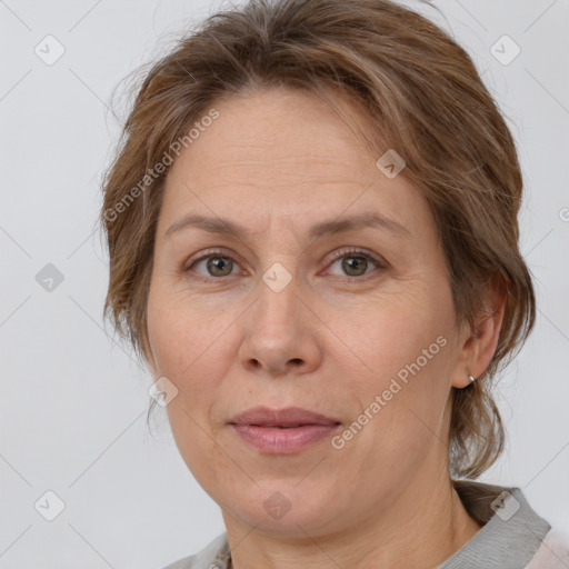 Joyful white adult female with medium  brown hair and grey eyes