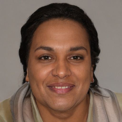 Joyful black adult female with short  brown hair and brown eyes