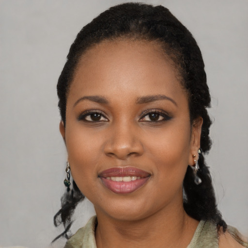 Joyful black young-adult female with long  black hair and brown eyes
