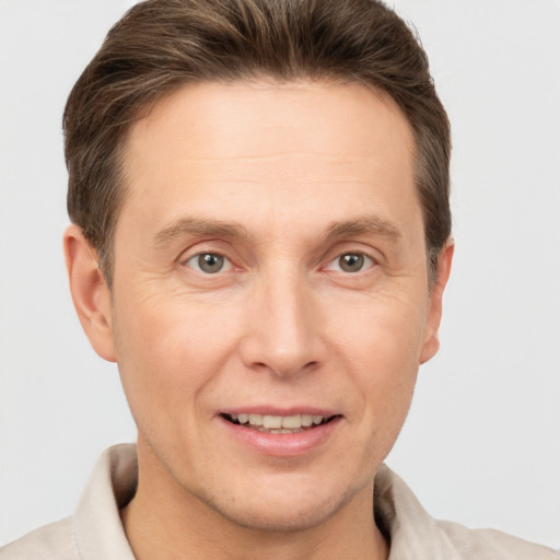 Joyful white adult male with short  brown hair and brown eyes