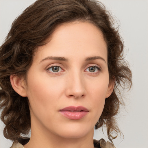 Joyful white young-adult female with medium  brown hair and green eyes