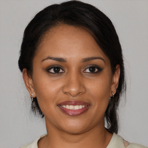 Joyful black young-adult female with medium  brown hair and brown eyes