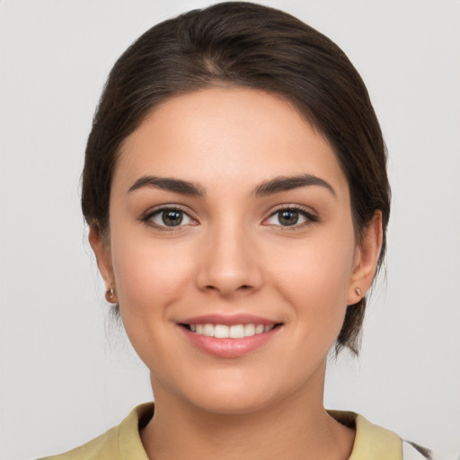 Joyful white young-adult female with medium  brown hair and brown eyes