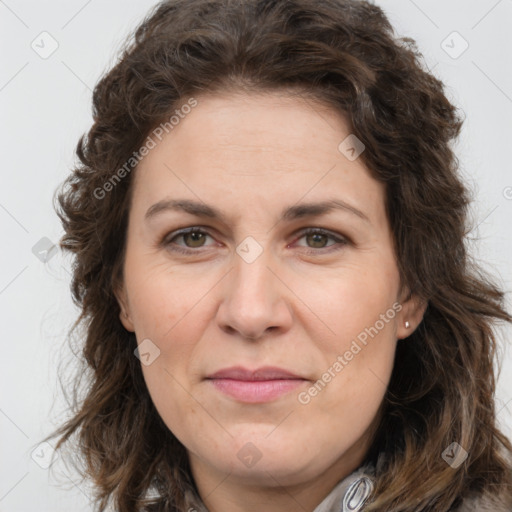 Joyful white adult female with long  brown hair and brown eyes