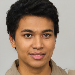 Joyful latino young-adult male with short  brown hair and brown eyes