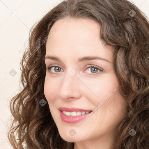 Joyful white young-adult female with long  brown hair and green eyes