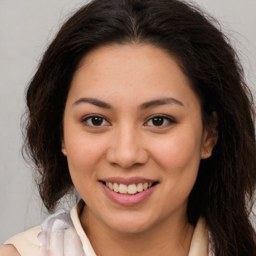 Joyful white young-adult female with long  brown hair and brown eyes