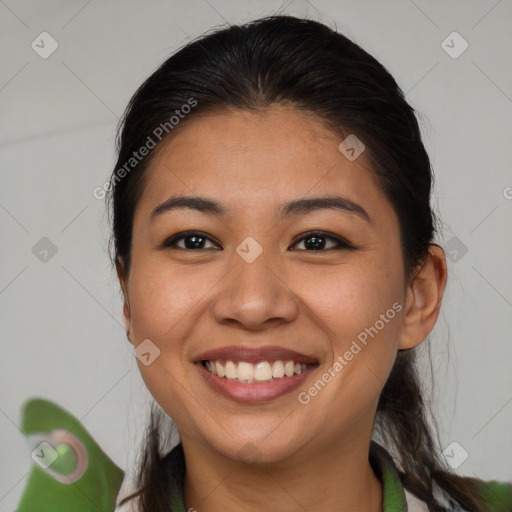 Joyful asian young-adult female with long  brown hair and brown eyes