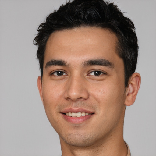 Joyful white young-adult male with short  black hair and brown eyes