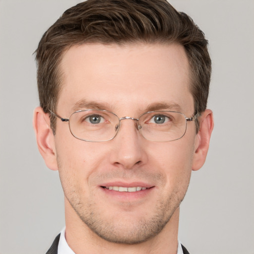 Joyful white adult male with short  brown hair and grey eyes