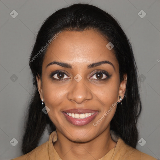 Joyful black young-adult female with long  black hair and brown eyes