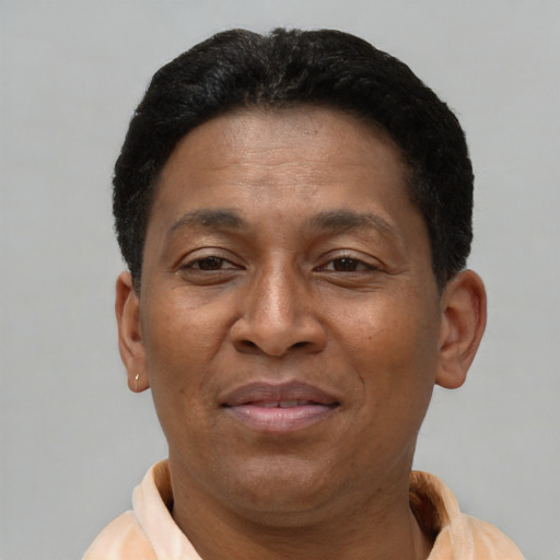 Joyful latino adult male with short  brown hair and brown eyes
