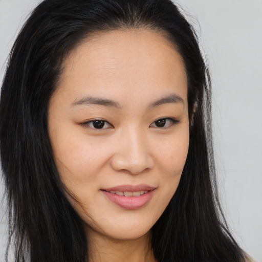 Joyful asian young-adult female with long  brown hair and brown eyes