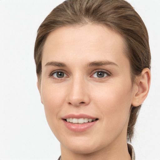 Joyful white young-adult female with medium  brown hair and grey eyes