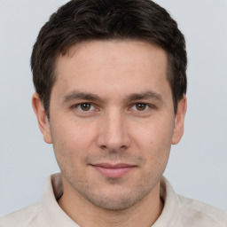 Joyful white young-adult male with short  brown hair and brown eyes