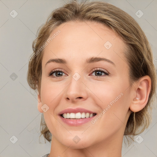 Joyful white young-adult female with medium  brown hair and grey eyes