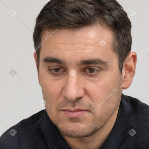 Joyful white adult male with short  brown hair and brown eyes