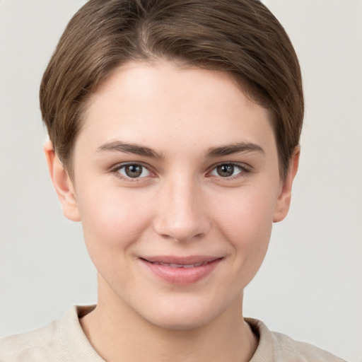 Joyful white young-adult female with short  brown hair and grey eyes