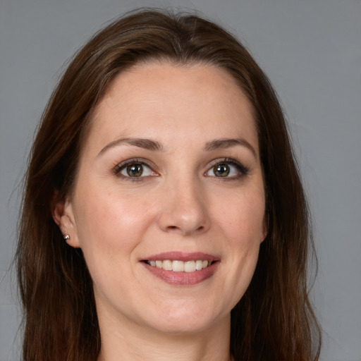 Joyful white young-adult female with long  brown hair and grey eyes