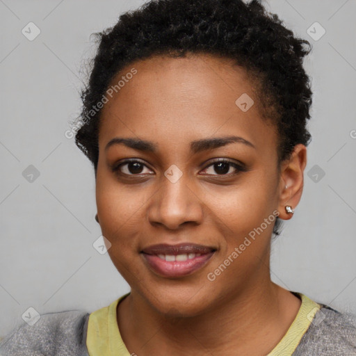 Joyful black young-adult female with short  black hair and brown eyes