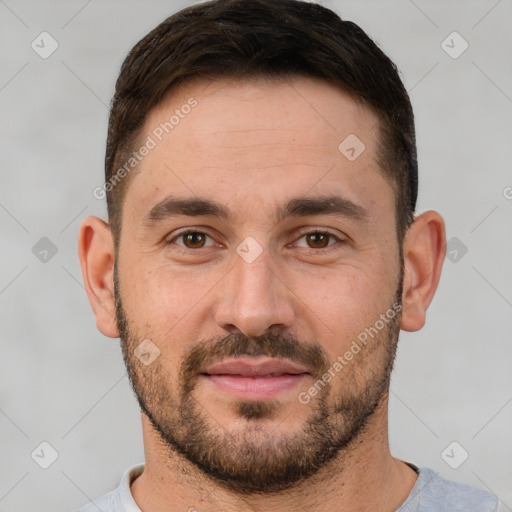 Joyful white young-adult male with short  brown hair and brown eyes