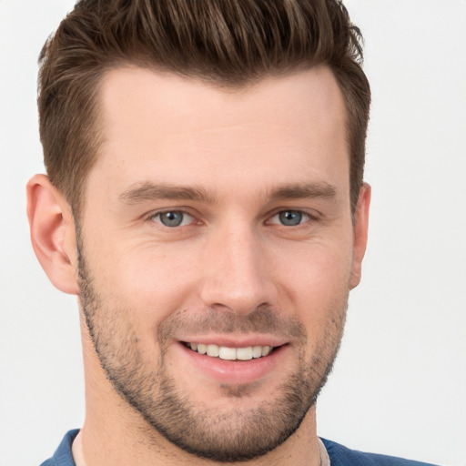 Joyful white young-adult male with short  brown hair and grey eyes