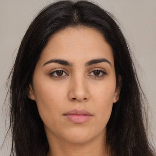 Neutral latino young-adult female with long  brown hair and brown eyes