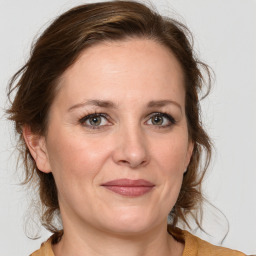 Joyful white adult female with medium  brown hair and grey eyes