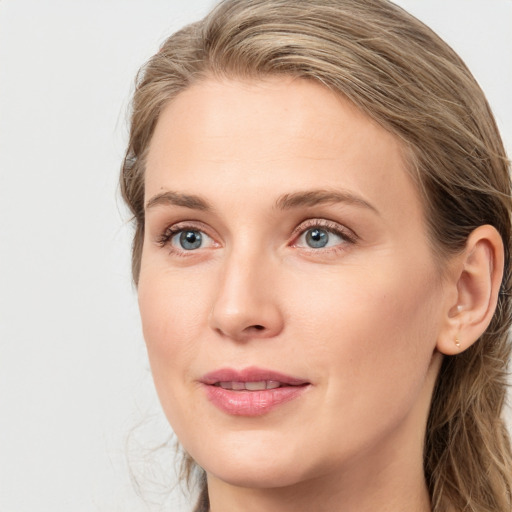 Joyful white young-adult female with long  brown hair and blue eyes