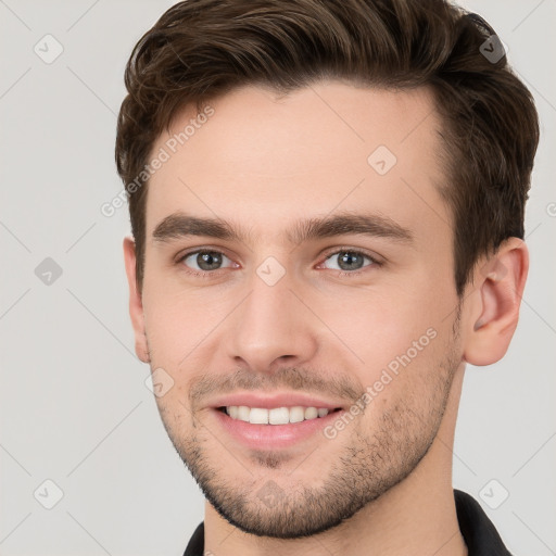 Joyful white young-adult male with short  brown hair and brown eyes