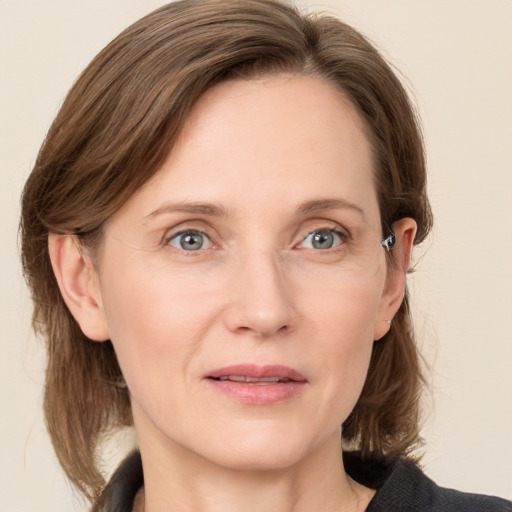 Joyful white adult female with medium  brown hair and grey eyes