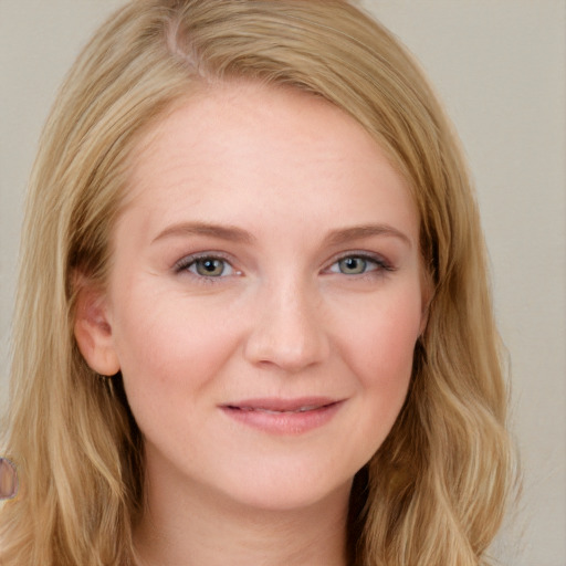 Joyful white young-adult female with long  brown hair and blue eyes