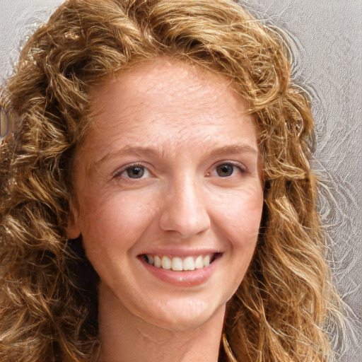 Joyful white young-adult female with long  brown hair and green eyes