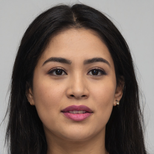 Joyful asian young-adult female with long  brown hair and brown eyes